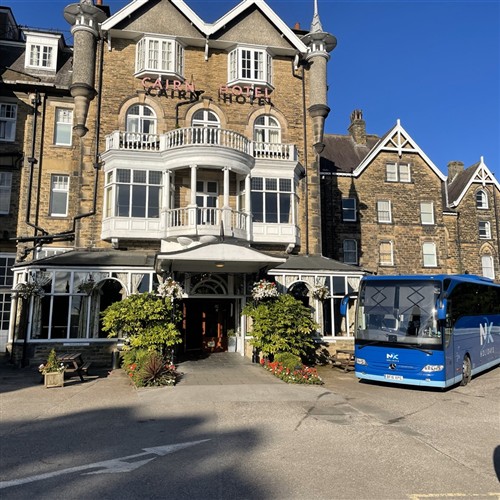 a photo of the coach outside the Carin hotel 