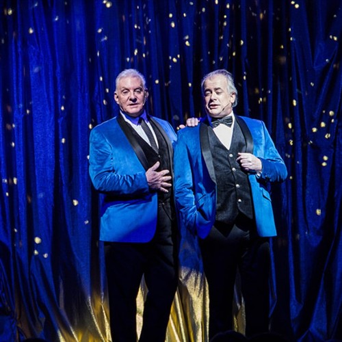 A photo of performers performing Rat Pack 